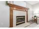 Close-up of a fireplace with a decorative wooden mantle and white tile surround at 2239 S Cottonwood --, Mesa, AZ 85202