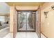 Elegant foyer featuring decorative wood and wrought iron doors, and views into the living room at 2239 S Cottonwood --, Mesa, AZ 85202