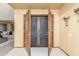 Elegant foyer featuring decorative wood doors, and views into the living room at 2239 S Cottonwood --, Mesa, AZ 85202