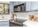 Close-up of a modern kitchen counter featuring an electric stove and a built-in microwave at 2239 S Cottonwood --, Mesa, AZ 85202