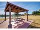The picnic table under a shelter overlooking the pond serves as a community gathering place for outdoor meals at 2239 S Cottonwood --, Mesa, AZ 85202