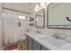 Bathroom featuring double vanity, shower with tub, and white subway tile at 2305 E Millbrae Ct, Gilbert, AZ 85234