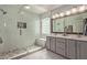 Bathroom featuring double sinks, quartz countertop, and glass shower at 2305 E Millbrae Ct, Gilbert, AZ 85234