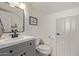 A stylish half bath with a dark faucet and a large wall mirror at 2305 E Millbrae Ct, Gilbert, AZ 85234