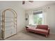 Bedroom featuring a plush pink couch, shelf, and carpet flooring at 2305 E Millbrae Ct, Gilbert, AZ 85234