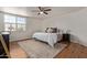 This bedroom features a large window, ceiling fan, and stylish rug at 2305 E Millbrae Ct, Gilbert, AZ 85234