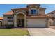 Charming two-story home with a tile roof, arched entryway, and two-car garage at 2305 E Millbrae Ct, Gilbert, AZ 85234