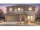 Inviting two-story home featuring a two-car garage and desert landscaping at 2428 S 246Th Ln, Buckeye, AZ 85326