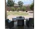 Paver patio with a firepit overlooking the lawn with stone groundcover and palm trees at 2665 E Gillcrest Rd, Gilbert, AZ 85298