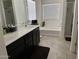 Bathroom featuring double sinks, vanity, bathtub, and glass-enclosed shower at 2665 E Gillcrest Rd, Gilbert, AZ 85298