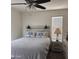 Cozy bedroom featuring a ceiling fan, stylish headboard, bedside table, and soft natural light at 2665 E Gillcrest Rd, Gilbert, AZ 85298