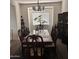 Dining room featuring a dark wooden table, carpet flooring, and a window for natural light at 2665 E Gillcrest Rd, Gilbert, AZ 85298