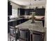 Spacious kitchen featuring black cabinets, stainless appliances, and a granite island at 2665 E Gillcrest Rd, Gilbert, AZ 85298