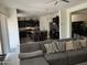 Open-concept living room flowing to kitchen with a gray sofa at 2665 E Gillcrest Rd, Gilbert, AZ 85298