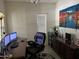 Home office featuring a dark desk, leather chair, and a traditional display cabinet at 2665 E Gillcrest Rd, Gilbert, AZ 85298