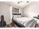 A serene bedroom with a dark wood bed frame and a window that lets in natural light at 2727 N Price Rd # 3, Chandler, AZ 85224
