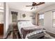 A cozy bedroom features a ceiling fan, warm color accents, and natural light from two windows at 2727 N Price Rd # 3, Chandler, AZ 85224
