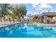 Sparkling community pool with lounge chairs and covered seating area at 2727 N Price Rd # 3, Chandler, AZ 85224