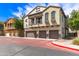 Attractive townhome featuring a balcony and three-car garage on a sunny day at 2727 N Price Rd # 3, Chandler, AZ 85224