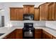 Well-equipped kitchen featuring wooden cabinetry, modern appliances, and ample counter space at 2727 N Price Rd # 3, Chandler, AZ 85224