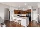 An open kitchen features wood cabinets, a breakfast bar with stools, and stainless steel appliances at 2727 N Price Rd # 3, Chandler, AZ 85224