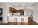 Bright open kitchen with wood cabinets, breakfast bar with seating, and modern appliances for a cozy atmosphere at 2727 N Price Rd # 3, Chandler, AZ 85224