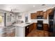 Modern kitchen with stainless steel appliances, a large island, and hardwood floors at 2727 N Price Rd # 3, Chandler, AZ 85224