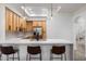 Modern kitchen with stainless appliances, skylight, quartz countertops, and light wood cabinets at 28990 N White Feather Ln # 121, Scottsdale, AZ 85262