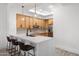 Bright kitchen featuring stainless steel appliances, wood cabinets, and eat-in bar at 28990 N White Feather Ln # 121, Scottsdale, AZ 85262