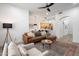 Open-concept living room with wood floors and views of kitchen and dining area at 28990 N White Feather Ln # 121, Scottsdale, AZ 85262