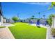 The backyard features a manicured lawn and an outdoor seating area, enhanced with lush landscaping at 2926 N 16Th Ave, Phoenix, AZ 85015