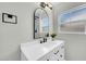 Bathroom with white vanity, oval mirror, modern fixtures and natural light at 2926 N 16Th Ave, Phoenix, AZ 85015