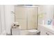 Bathroom featuring a shower-tub combo with sliding doors, toilet, and vanity sink at 3017 E Bluefield Ave, Phoenix, AZ 85032