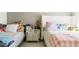 This bedroom features two inviting beds, patterned wallpaper, and stylish decor at 3017 E Bluefield Ave, Phoenix, AZ 85032