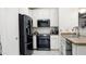 Functional kitchen with black appliances, white cabinets, and laminate countertops at 3017 E Bluefield Ave, Phoenix, AZ 85032
