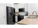 Kitchen with black refrigerator, white cabinets, and stainless-steel appliances at 3017 E Bluefield Ave, Phoenix, AZ 85032