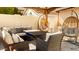 Cozy covered patio area with comfortable seating and stylish hanging chairs at 3017 E Bluefield Ave, Phoenix, AZ 85032