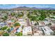 Aerial view of a neighborhood featuring houses, green trees, and mountain views at 3029 W Sierra St, Phoenix, AZ 85029