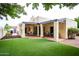 Exterior of home with covered patio overlooking lush green grass and desert landscaping at 3029 W Sierra St, Phoenix, AZ 85029