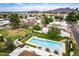 Lush backyard featuring a pool, lounge area and beautifully maintained landscaping surrounded by homes at 3029 W Sierra St, Phoenix, AZ 85029