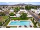 Aerial view of a backyard oasis featuring a private pool, lounge chairs, and manicured green lawn at 3029 W Sierra St, Phoenix, AZ 85029