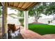 Backyard patio with tile and grass yard surrounded by a wall and large shade tree at 3029 W Sierra St, Phoenix, AZ 85029