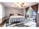 Bedroom with sliding glass doors to patio, a fan, and a decorative rug at 3029 W Sierra St, Phoenix, AZ 85029