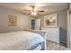 Bedroom featuring a white dresser, mirror, ceiling fan, and neutral wall color at 3029 W Sierra St, Phoenix, AZ 85029