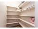 Walk in closet with ample white shelving for organized storage at 3029 W Sierra St, Phoenix, AZ 85029