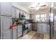 Kitchen showcasing stainless steel appliances, light grey cabinets, and a patterned backsplash at 3029 W Sierra St, Phoenix, AZ 85029