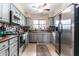 Updated kitchen with stainless appliances, grey cabinets, and stylish backsplash over wood countertops at 3029 W Sierra St, Phoenix, AZ 85029