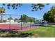 Fenced tennis courts with green and red surface under clear blue sky at 3029 W Sierra St, Phoenix, AZ 85029