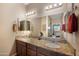 Bathroom featuring double vanity sinks with granite countertops, wood cabinetry, and modern fixtures at 3117 S Signal Butte Rd # 484, Mesa, AZ 85212