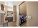 Bathroom view showcasing a closet with an organized wardrobe and well-lit vanity area with an expansive mirror at 3117 S Signal Butte Rd # 484, Mesa, AZ 85212